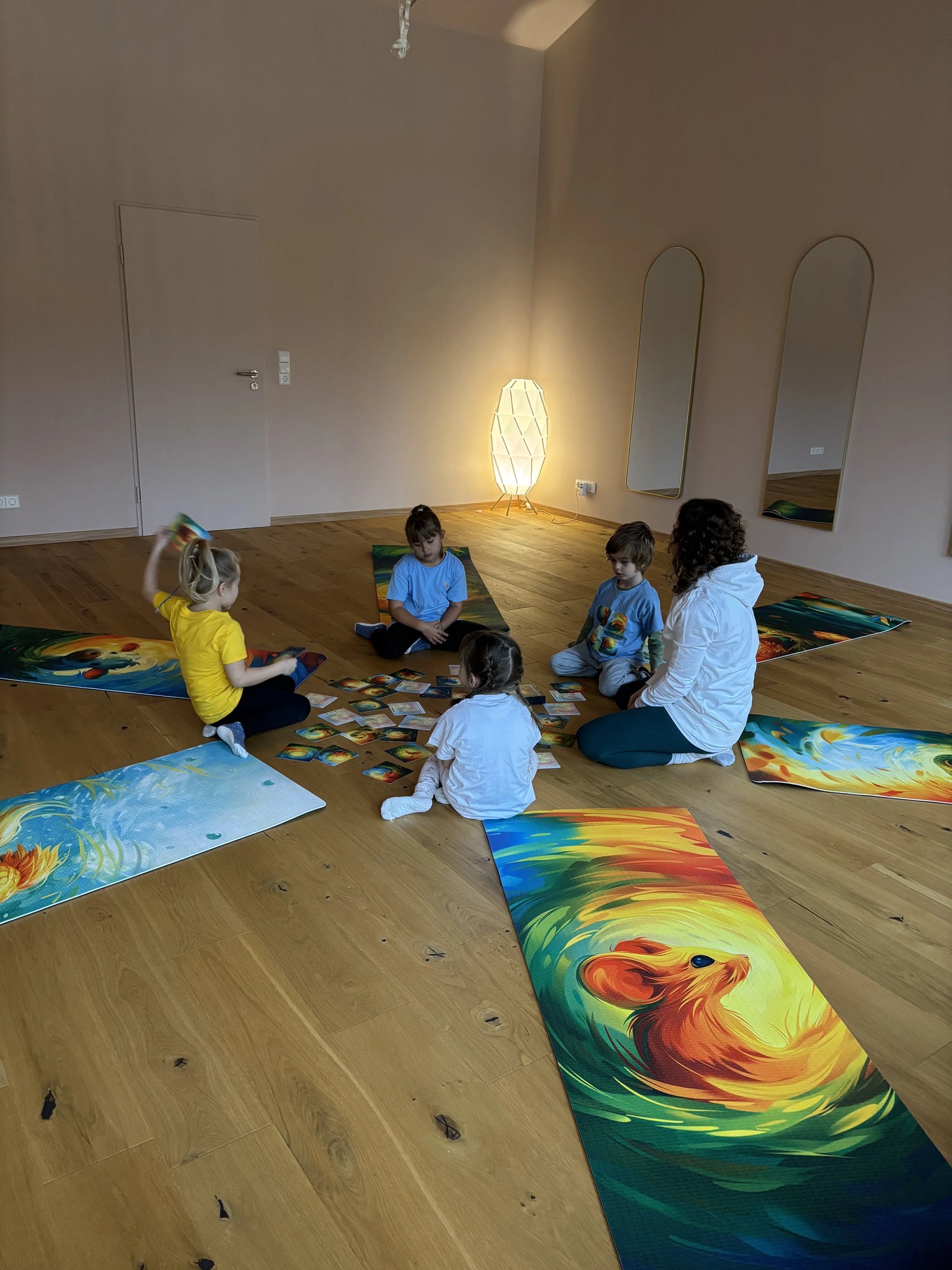 Kinder üben Kinderyoga im Kreis auf bunten Yogamatten